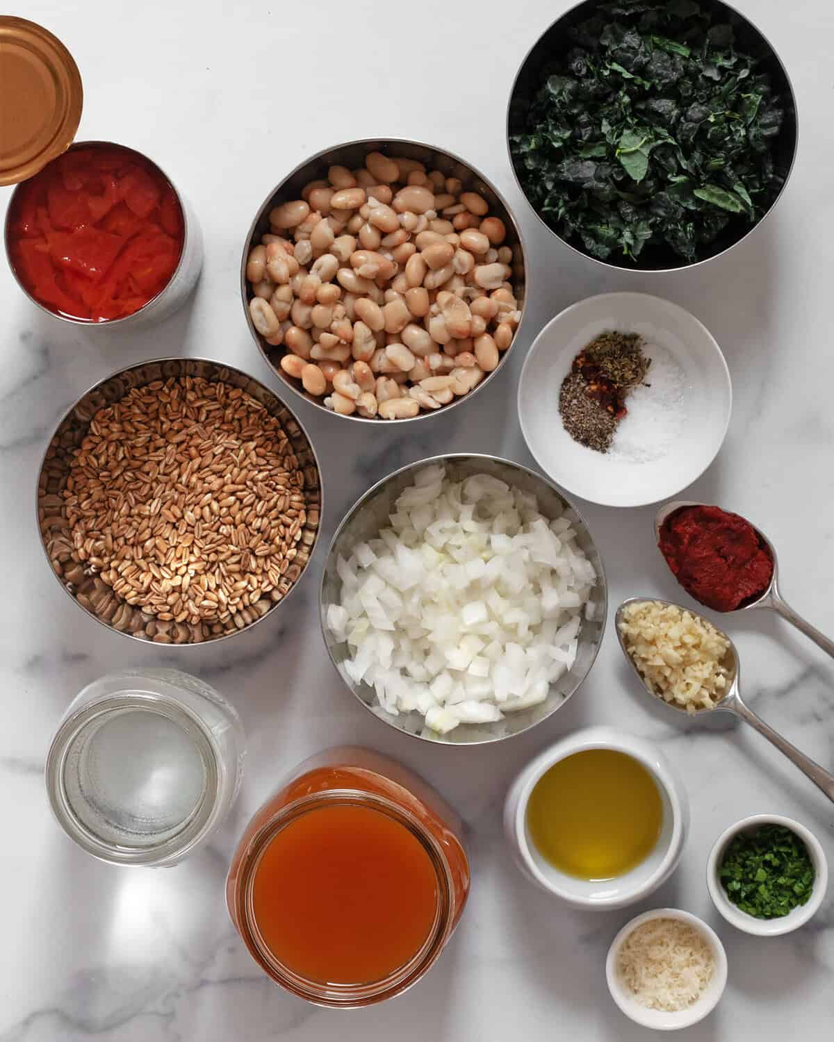 Ingredients including, tomato, farro, white beans, onions, seasonings, olive oil, tomato paste, garlic and vegetable broth.