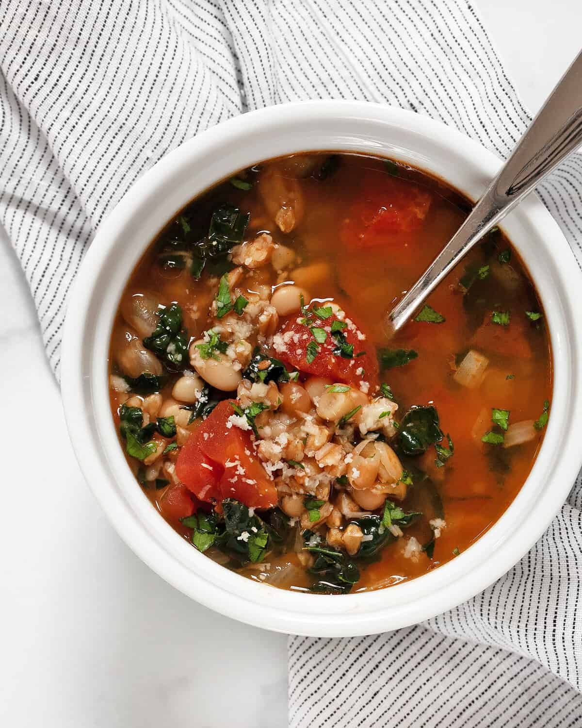 Bowl of tomato white bean farro soup.