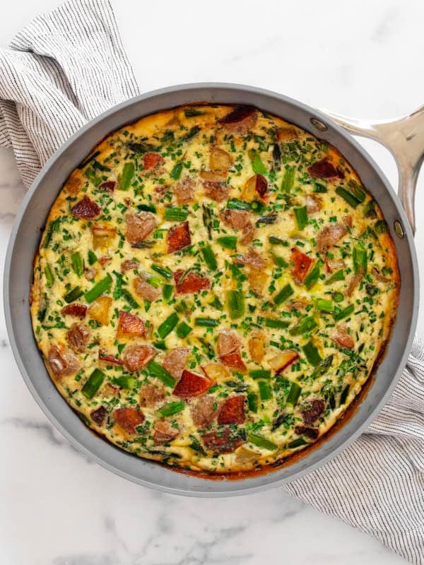 Roasted asparagus frittata in a skillet.