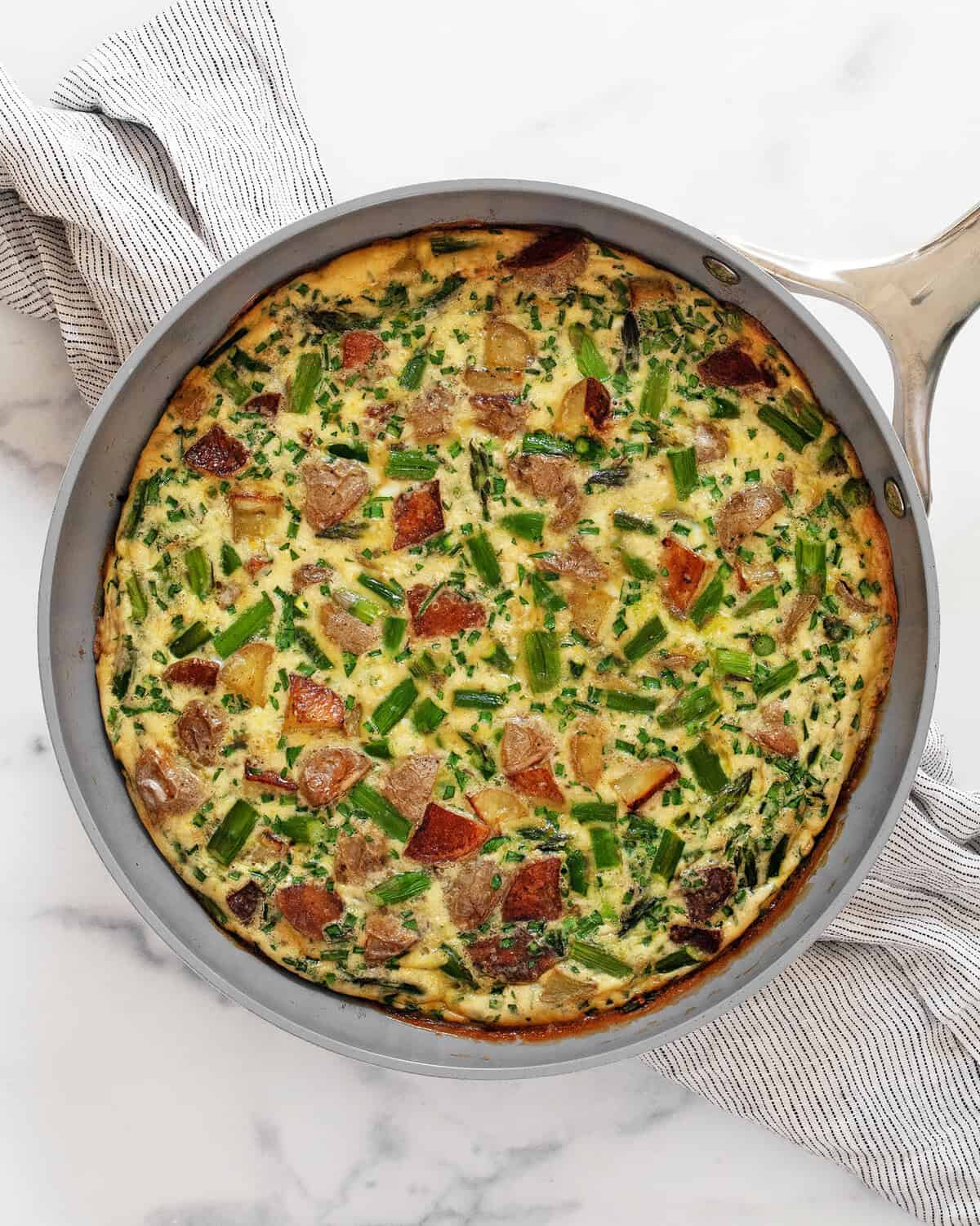 Roasted asparagus frittata in a skillet.