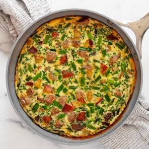 Roasted asparagus frittata in a skillet.