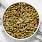 Artichoke pasta with spinach pesto in a bowl.