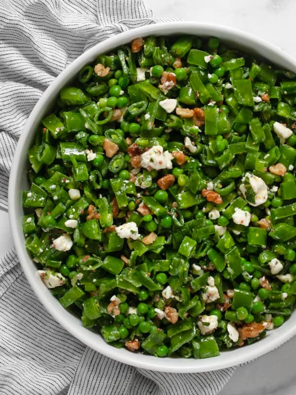 Three pea salad in a large serving bowl.