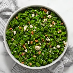 Three pea salad in a large serving bowl.