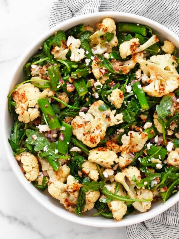 Roasted asparagus cauliflower salad in a bowl.