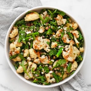 Roasted asparagus cauliflower salad in a bowl.