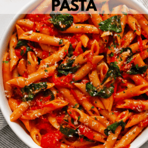 Spinach tomato pasta in a serving bowl.