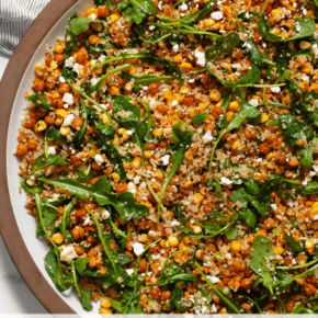 Roasted corn chickpea quinoa salad on a serving plate.