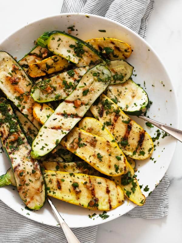 Grilled zucchini and yellow squash tossed with gremolata in a bowl.