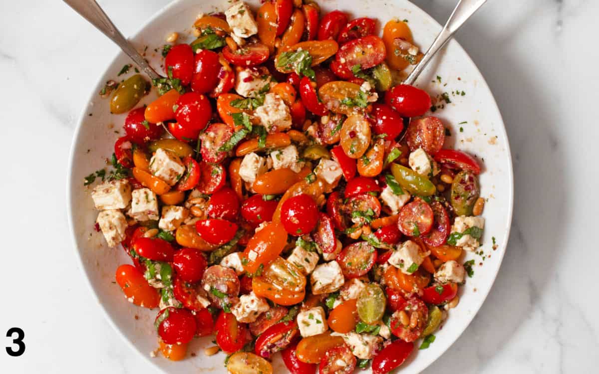 Basil and pine nuts stirred into tomato salad.