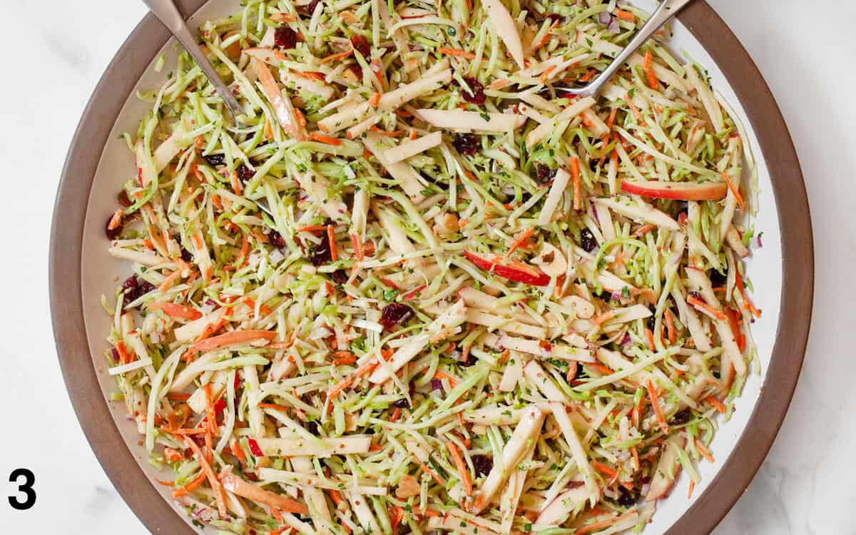 Salad tossed with dressing in a large bowl.